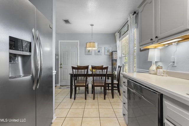 13625 Mount Pleasant Rd, Vancleave, MS 39565 - kitchen with appliances with stainless steel finishes, light countertops, hanging light fixtures, and light tile patterned flooring