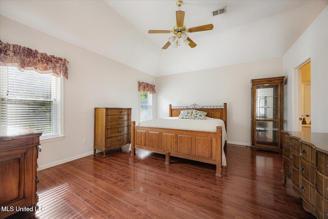 bedroom featuring visible vents, baseboards, lofted ceiling, and dark wood-style floors