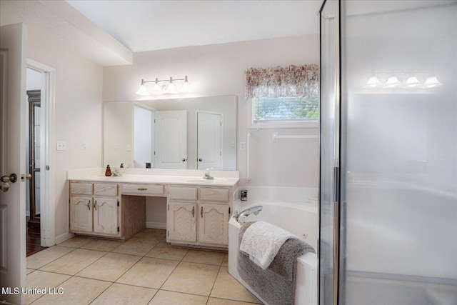 full bathroom featuring tile patterned flooring, double vanity, a sink, and a bath