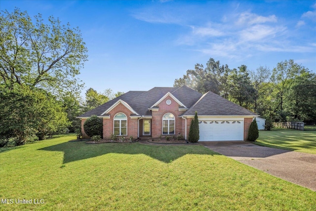single story home featuring brick siding, a garage, a front lawn, and driveway