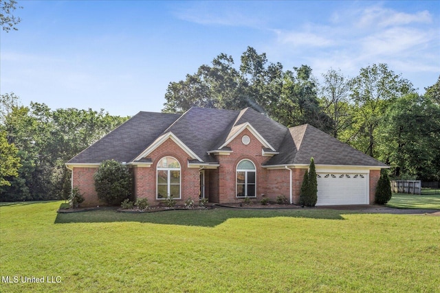 view of front of home with driveway, a front yard, a garage, brick siding, and a shingled roof