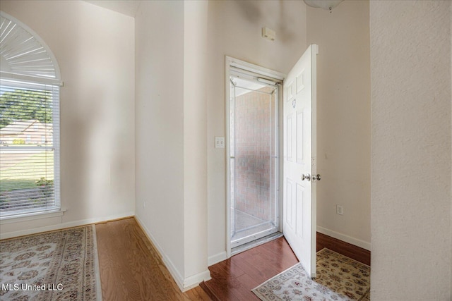 bathroom with baseboards and wood finished floors