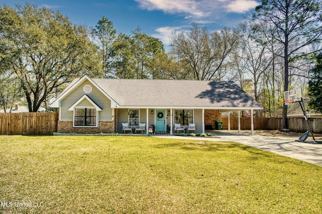 ranch-style home featuring fence, concrete driveway, a front yard, an attached carport, and brick siding