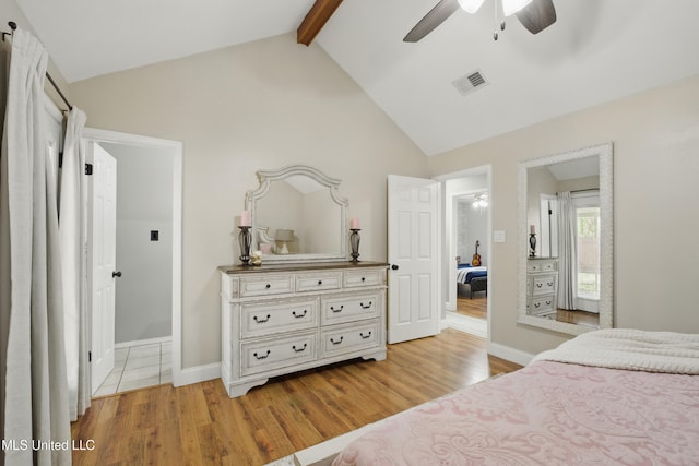 bedroom featuring visible vents, beamed ceiling, wood finished floors, baseboards, and ceiling fan