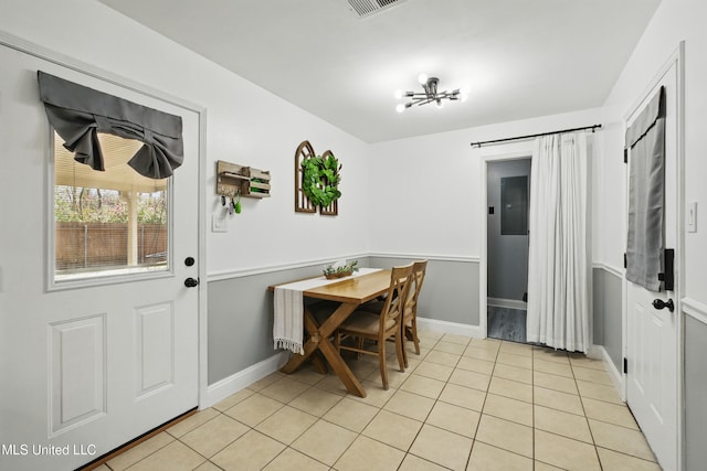 dining space featuring light tile patterned floors and baseboards