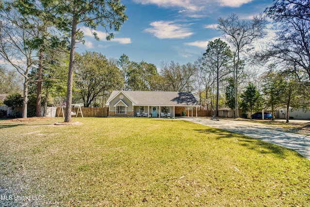 ranch-style house featuring brick siding, driveway, a front yard, and fence