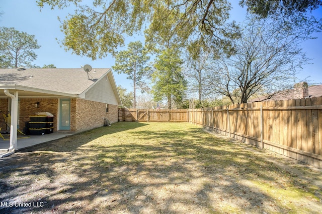 view of yard featuring a patio and a fenced backyard