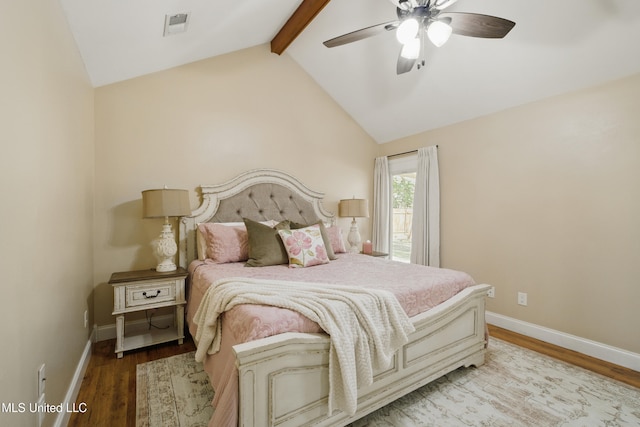 bedroom with visible vents, vaulted ceiling with beams, baseboards, and wood finished floors