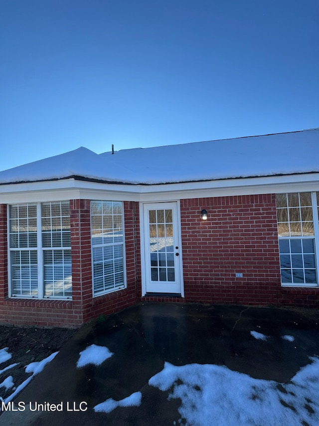 view of snow covered property entrance