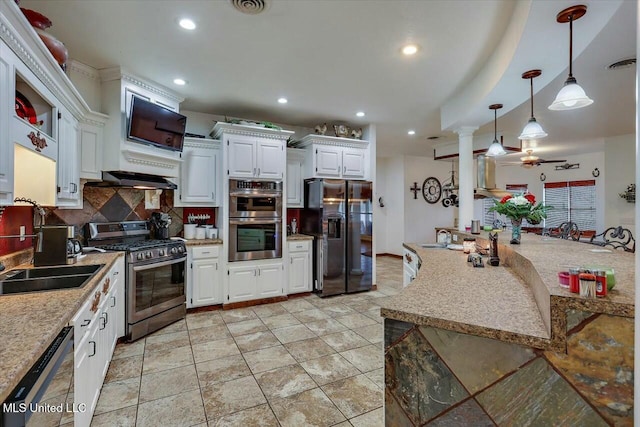 kitchen featuring sink, appliances with stainless steel finishes, pendant lighting, decorative backsplash, and white cabinets