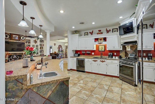 kitchen featuring sink, dishwasher, stainless steel gas stove, white cabinetry, and decorative light fixtures