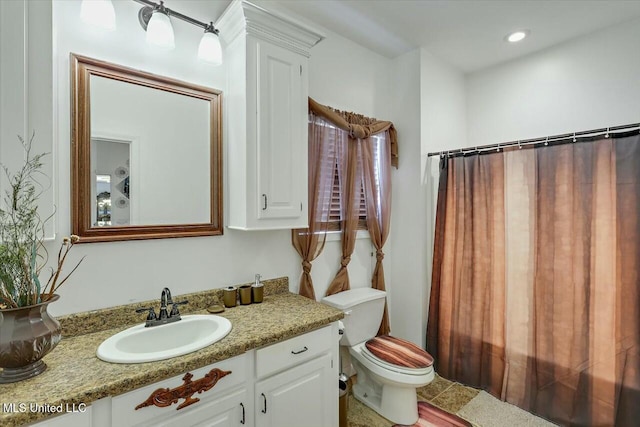 bathroom with vanity, toilet, and curtained shower