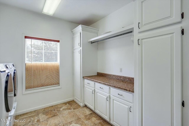 washroom with cabinets and washing machine and clothes dryer