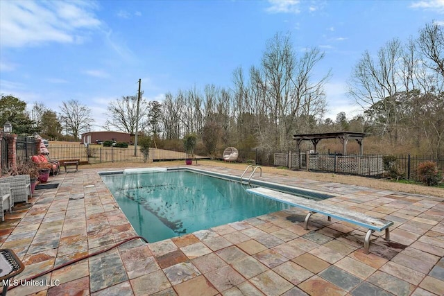 view of swimming pool featuring a patio, a diving board, and a gazebo