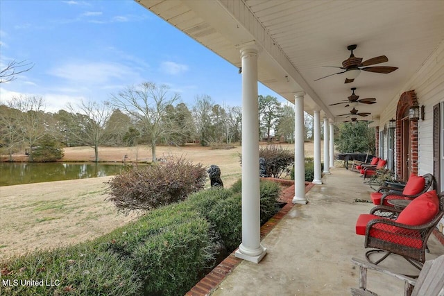 view of patio featuring covered porch, ceiling fan, and a water view