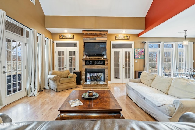 living room featuring light hardwood / wood-style floors and french doors