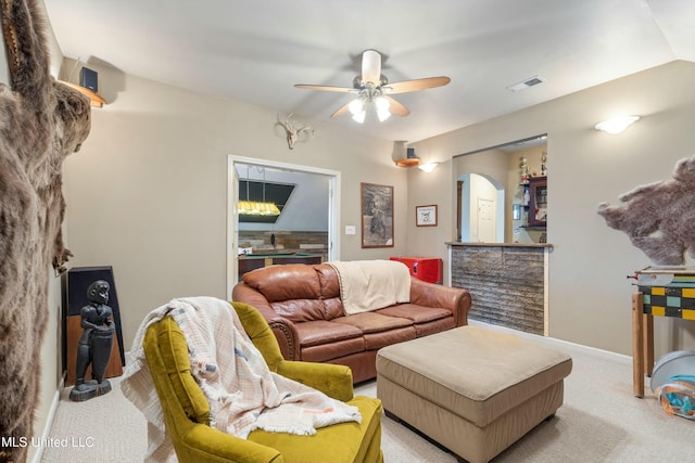 carpeted living room with ceiling fan