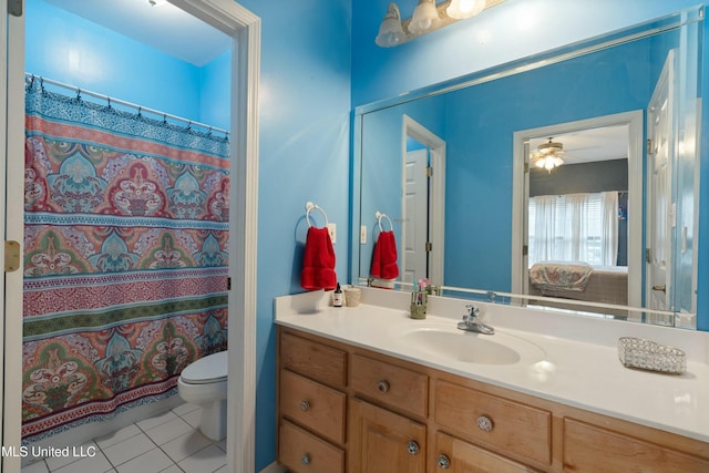 bathroom featuring vanity, tile patterned floors, and toilet