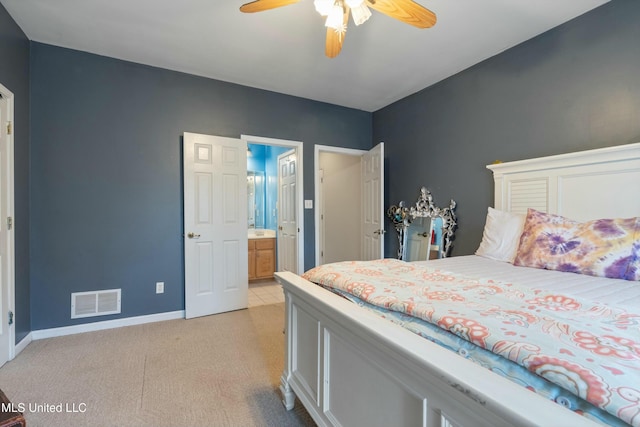 carpeted bedroom featuring ceiling fan and ensuite bathroom