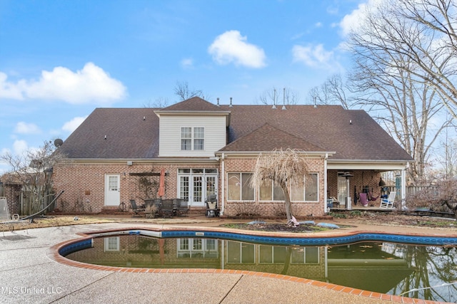 rear view of house featuring a sunroom, ceiling fan, and a patio area