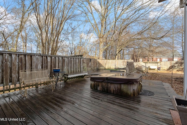 wooden deck with a hot tub