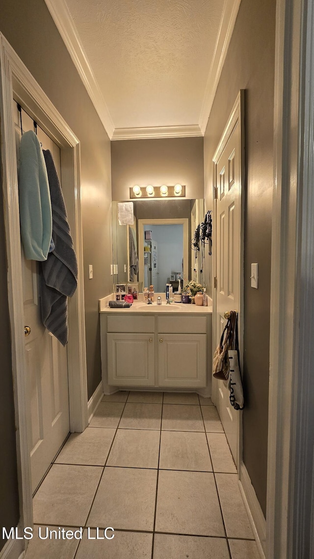 312 Grandview Ct, Pearl, MS 39208 - bathroom with tile patterned flooring, crown molding, vanity, a textured ceiling, and baseboards
