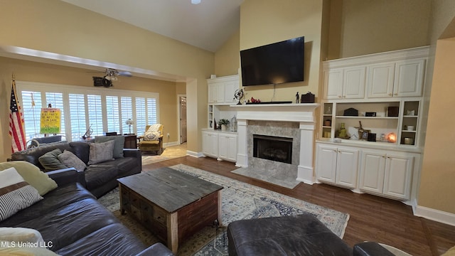 312 Grandview Ct, Pearl, MS 39208 - living room featuring dark wood-type flooring, a ceiling fan, a fireplace, high vaulted ceiling, and baseboards