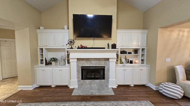 312 Grandview Ct, Pearl, MS 39208 - living room with lofted ceiling, dark wood-style flooring, a fireplace, and baseboards