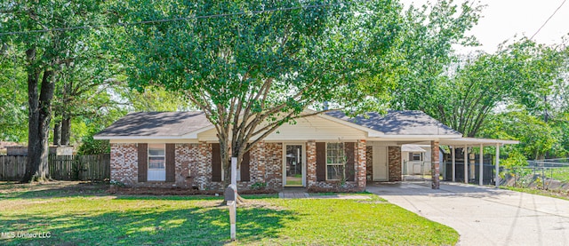 ranch-style home featuring a front lawn and a carport