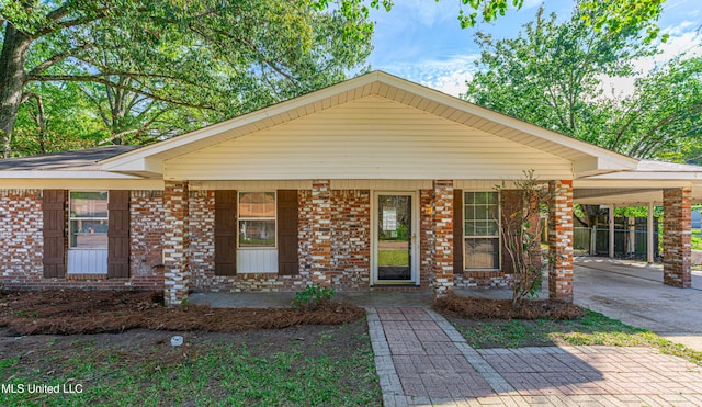 view of front facade with a porch and a carport