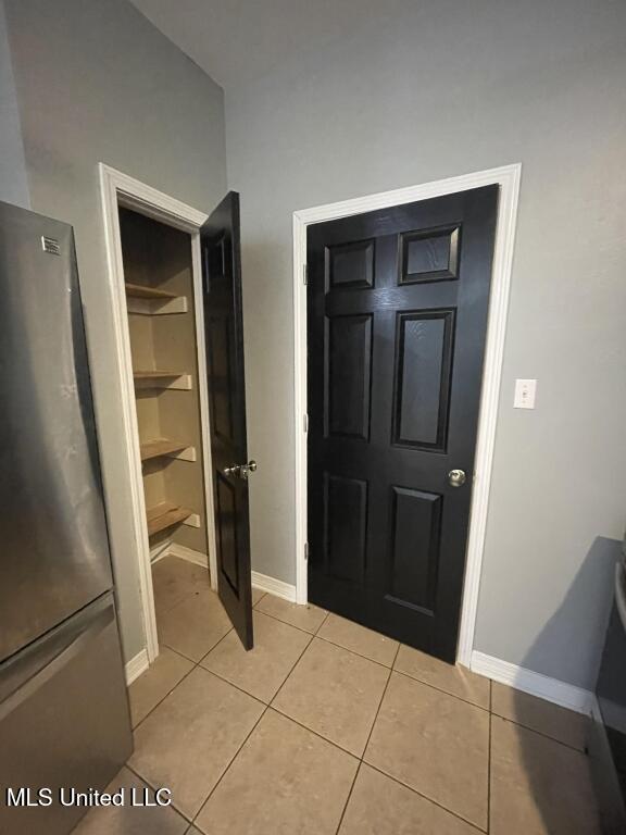 entryway with light tile patterned flooring