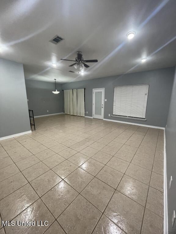 spare room with light tile patterned floors and ceiling fan