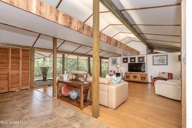 living room featuring hardwood / wood-style floors and lofted ceiling with beams