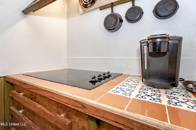 room details featuring black electric cooktop and tile counters