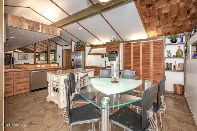 dining area with sink and vaulted ceiling