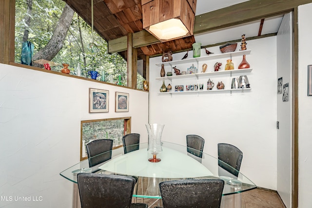 dining area featuring vaulted ceiling