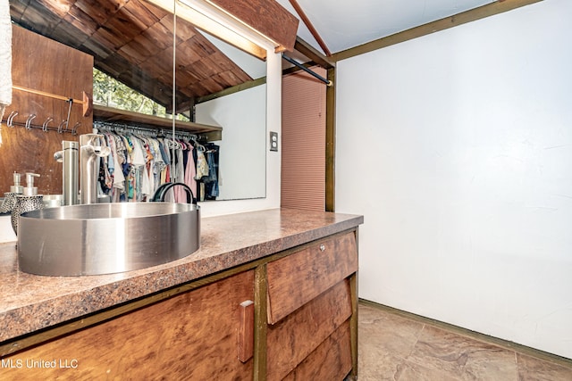 interior space featuring sink, vaulted ceiling, and wood ceiling