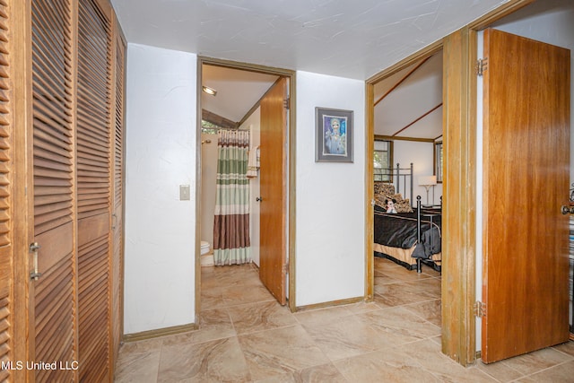 corridor featuring vaulted ceiling