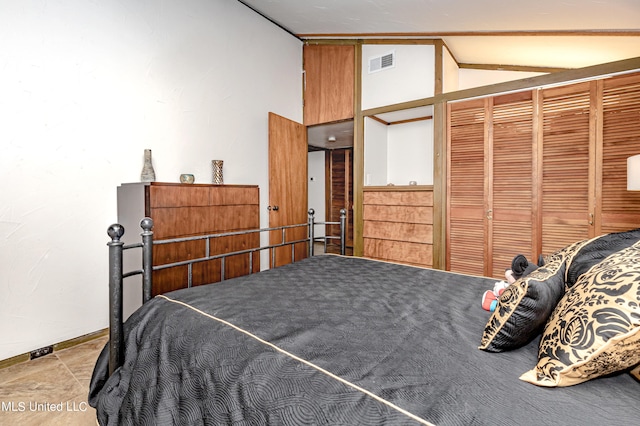 bedroom featuring a closet and lofted ceiling