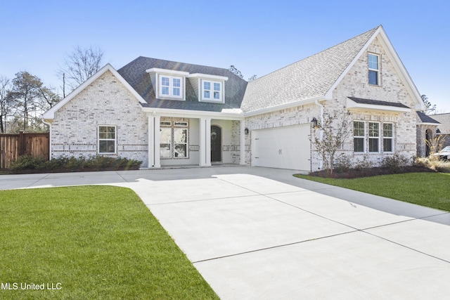 view of front facade with an attached garage, concrete driveway, a front lawn, and fence