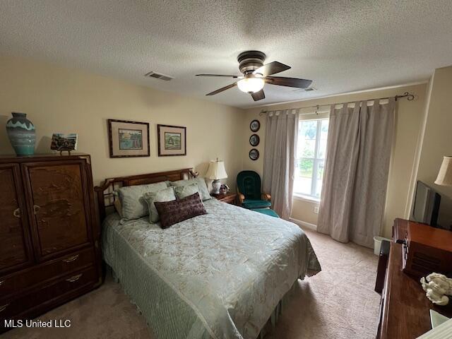 211 Fairway Trace Dr, Hernando, MS 38632 - bedroom featuring light colored carpet, a textured ceiling, and ceiling fan