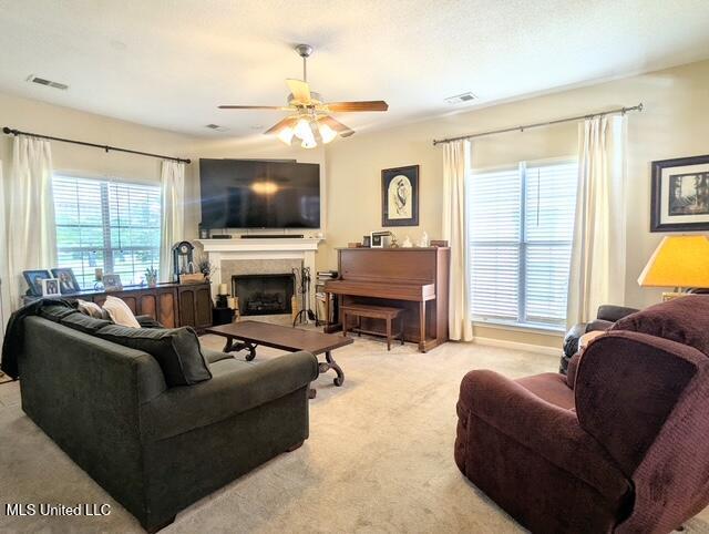 211 Fairway Trace Dr, Hernando, MS 38632 - living room with a fireplace, a ceiling fan, and carpet