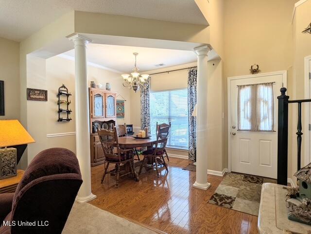 211 Fairway Trace Dr, Hernando, MS 38632 - dining space with ornate columns, wood finished floors, a chandelier, and baseboards