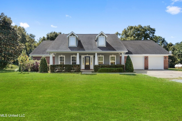 new england style home with a porch, a front lawn, and a garage