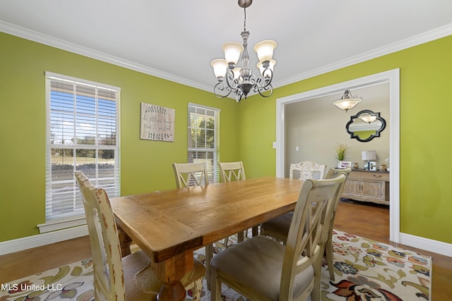 dining area featuring ornamental molding and a notable chandelier