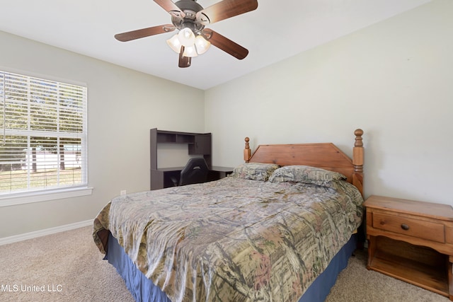 bedroom with light carpet and ceiling fan