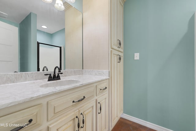 bathroom featuring vanity and a shower with shower door