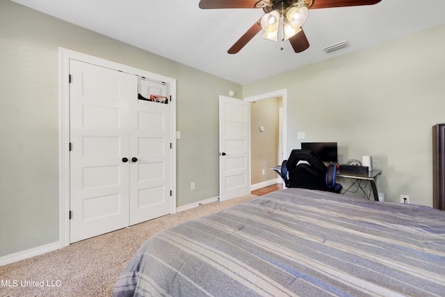 carpeted bedroom with a closet and ceiling fan