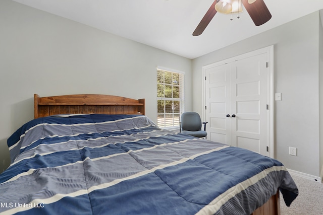 carpeted bedroom featuring a closet and ceiling fan