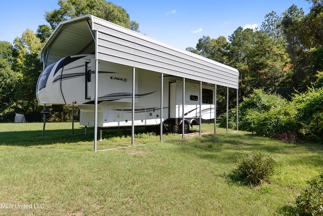 exterior space featuring a yard and a carport